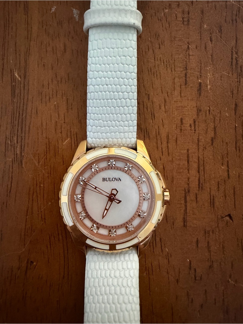 Bulova Gold Tone Watch with White Strap and Mother-of-Pearl Dial